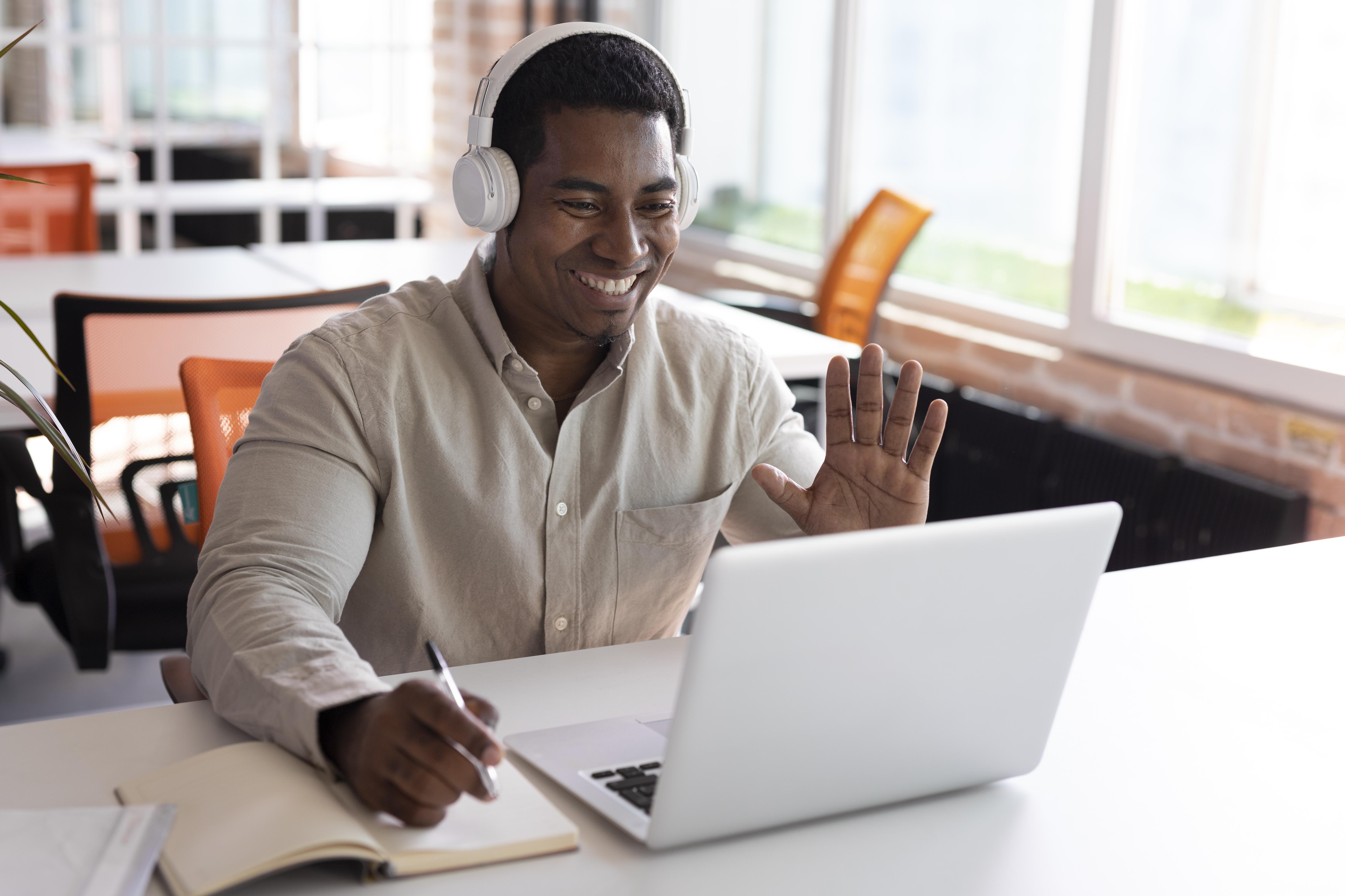 Tutor greeting students from a laptop